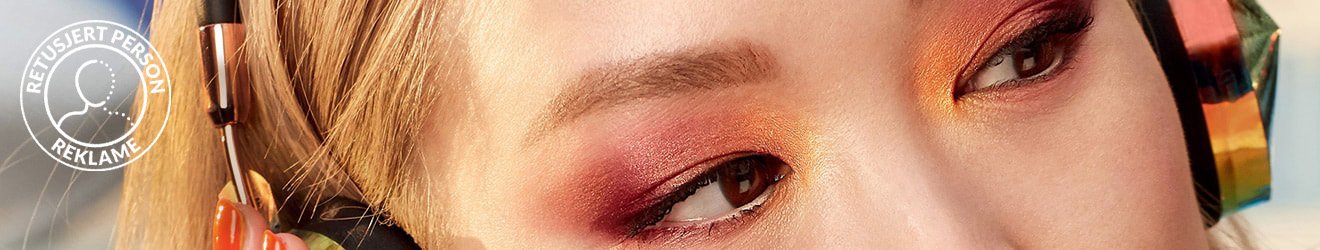 Maybelline Eyeshadow products illustrative banner image - Close up of blond Asian woman with headphones, wearing colorfull Eyeshadow